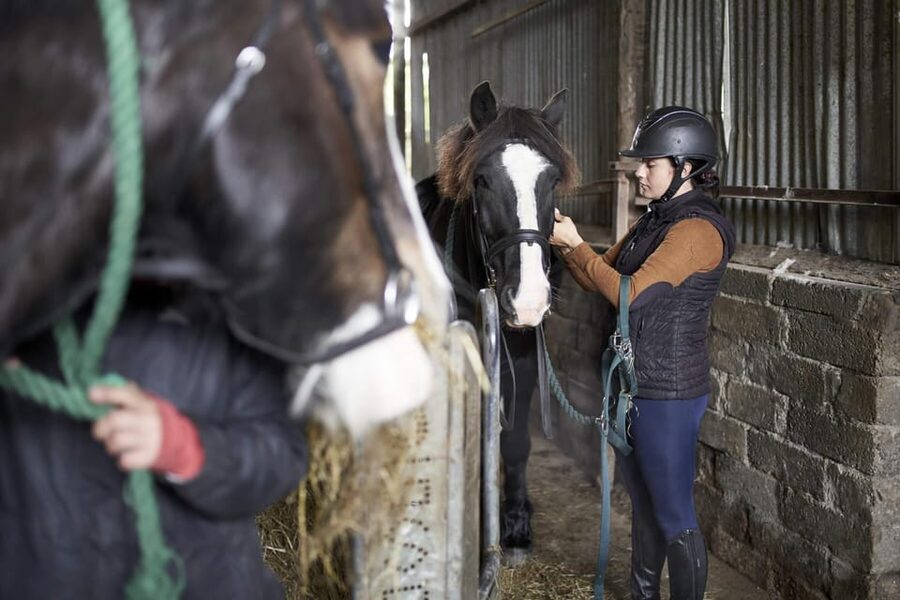 Westport: Beach and Countryside Guided Horse Ride - Getting fitted with boots and a riding hat